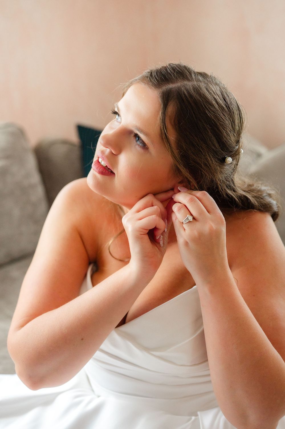 Close-up series of someone putting on earrings while getting ready.