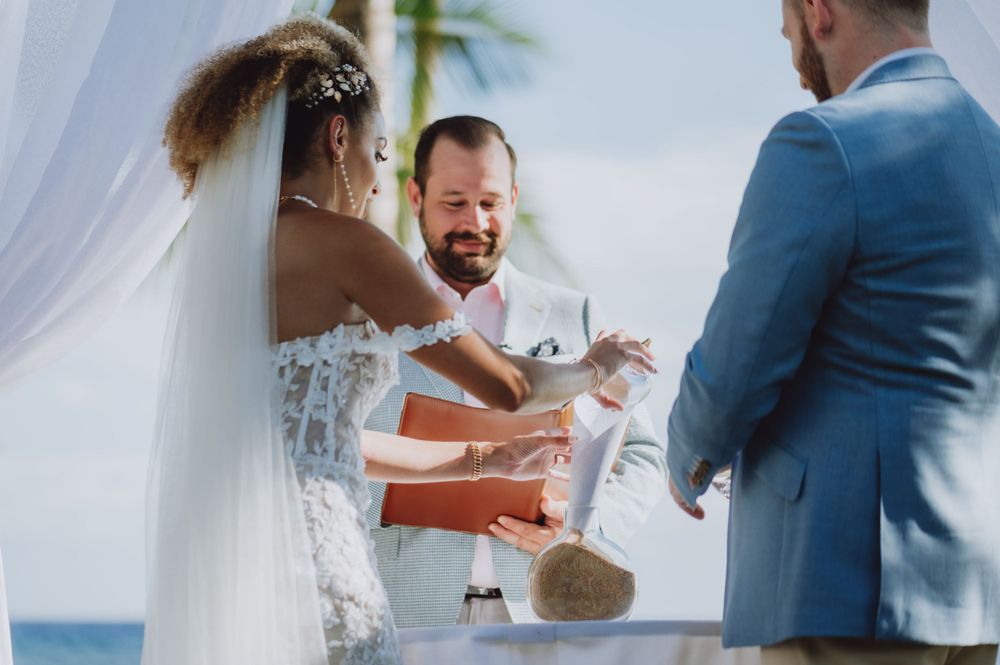 Joyful reactions during wedding vow exchange at an oceanfront ceremony.