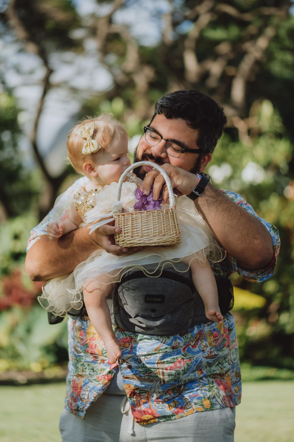 Sweet candid moments between parent and child during outdoor celebration.