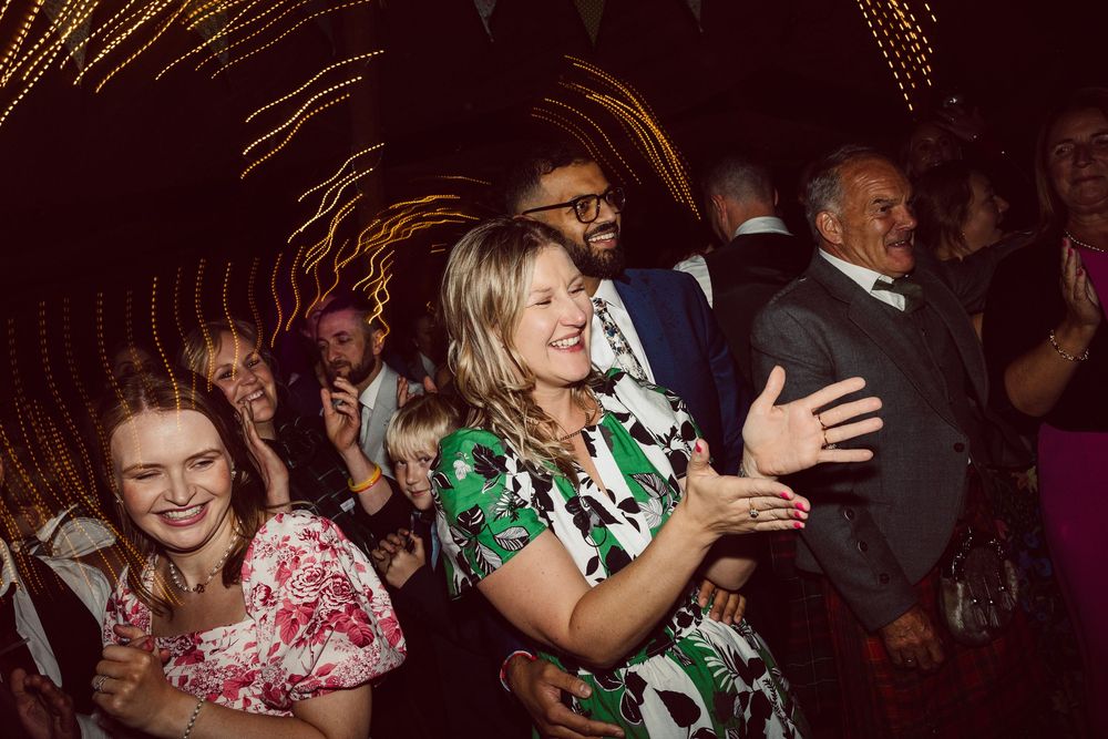 People dancing and enjoying themselves at a lively nighttime party or celebration event.