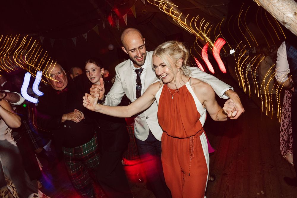 A group of people dancing and having fun at a lively party on a dance floor.