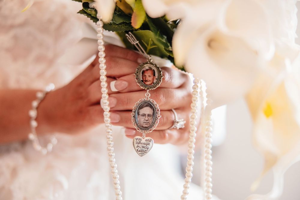 A string of delicate white pearl beads drapes elegantly against a soft pink background.