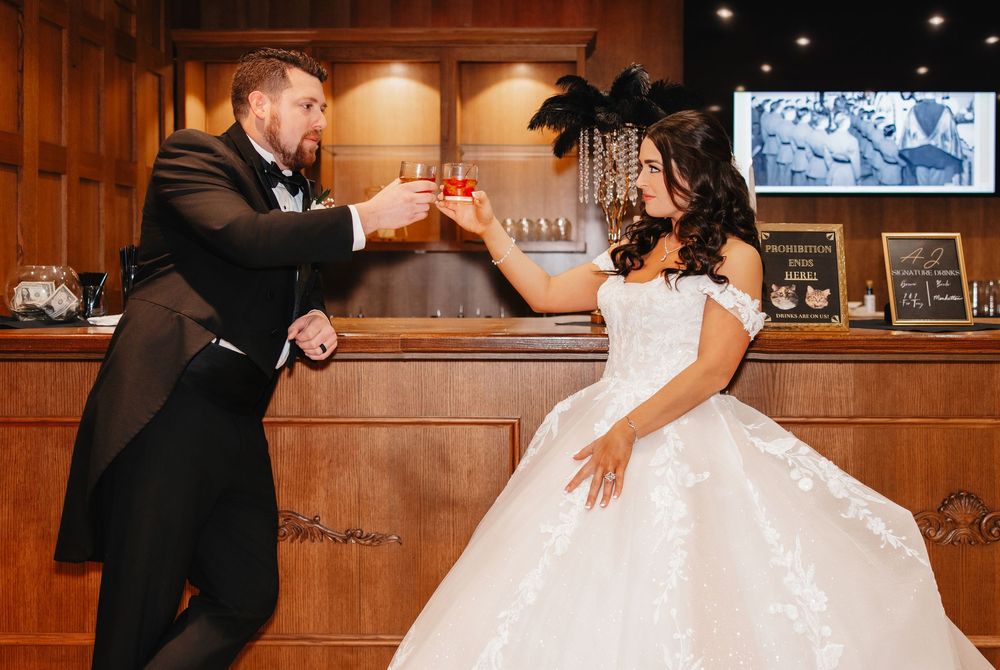 A couple shares an intimate dance together in an elegant wood-paneled room during a wedding reception.