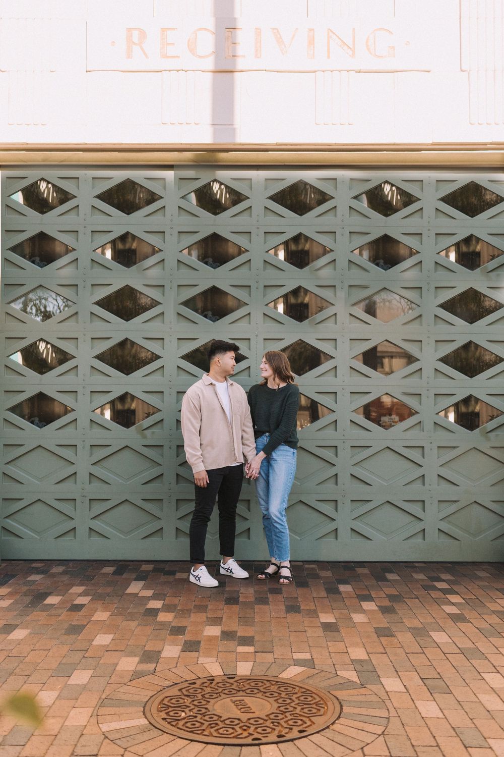 Four sequential photos showing people sitting against a teal geometric wall with brick pavement and a manhole cover.