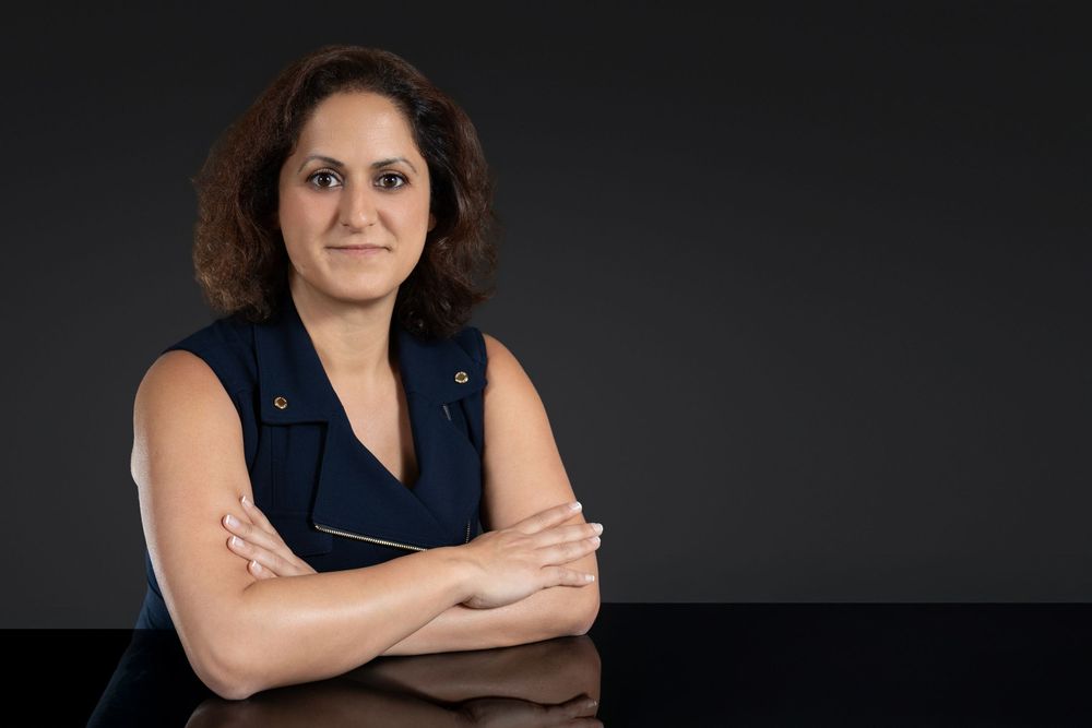 Professional headshot series against dark background showing different poses in business attire. In studio in Orlando, Florida