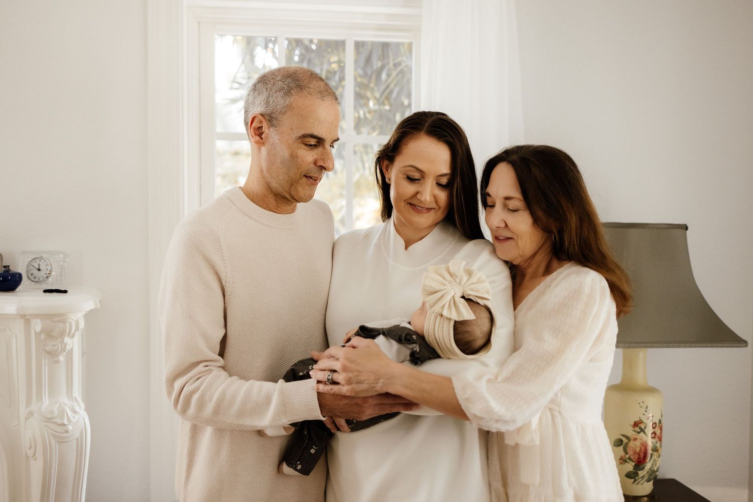 Family holds new baby at Los Gatos newborn photoshoot with Bay Area Newborn Photographer Cindy Tucey