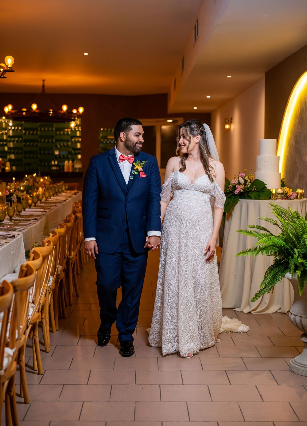 A sequence of five wedding photos showing a couple in evening formal wear walking together in an elegant indoor venue.