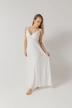 Minimalist white sundress shown in multiple angles against light studio backdrop.