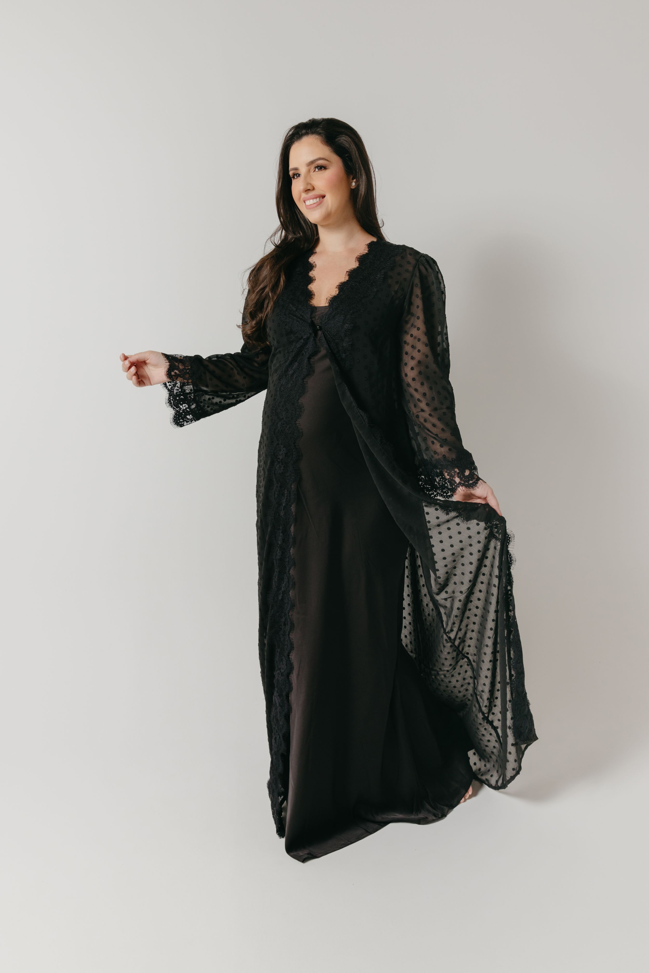 Elegant black sheer mesh cape or overlay garment shown draped on figure against white background.