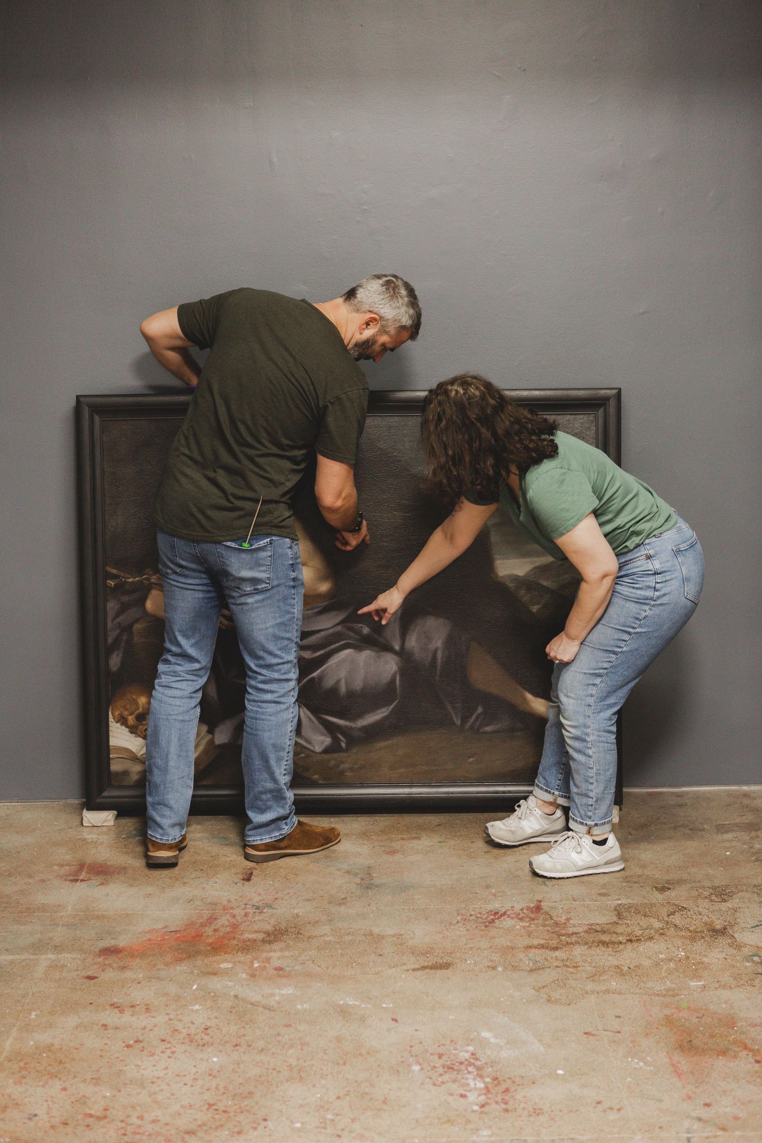 Step-by-step sequence showing installation of a baseboard along a dark wall with careful placement and positioning.