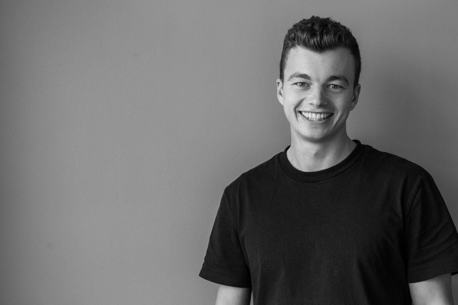 Black and white photo collage showing seven similar poses of someone in a dark t-shirt.