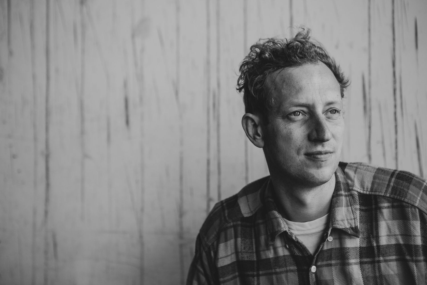 A series of four black and white headshots showing the same person in different thoughtful expressions.