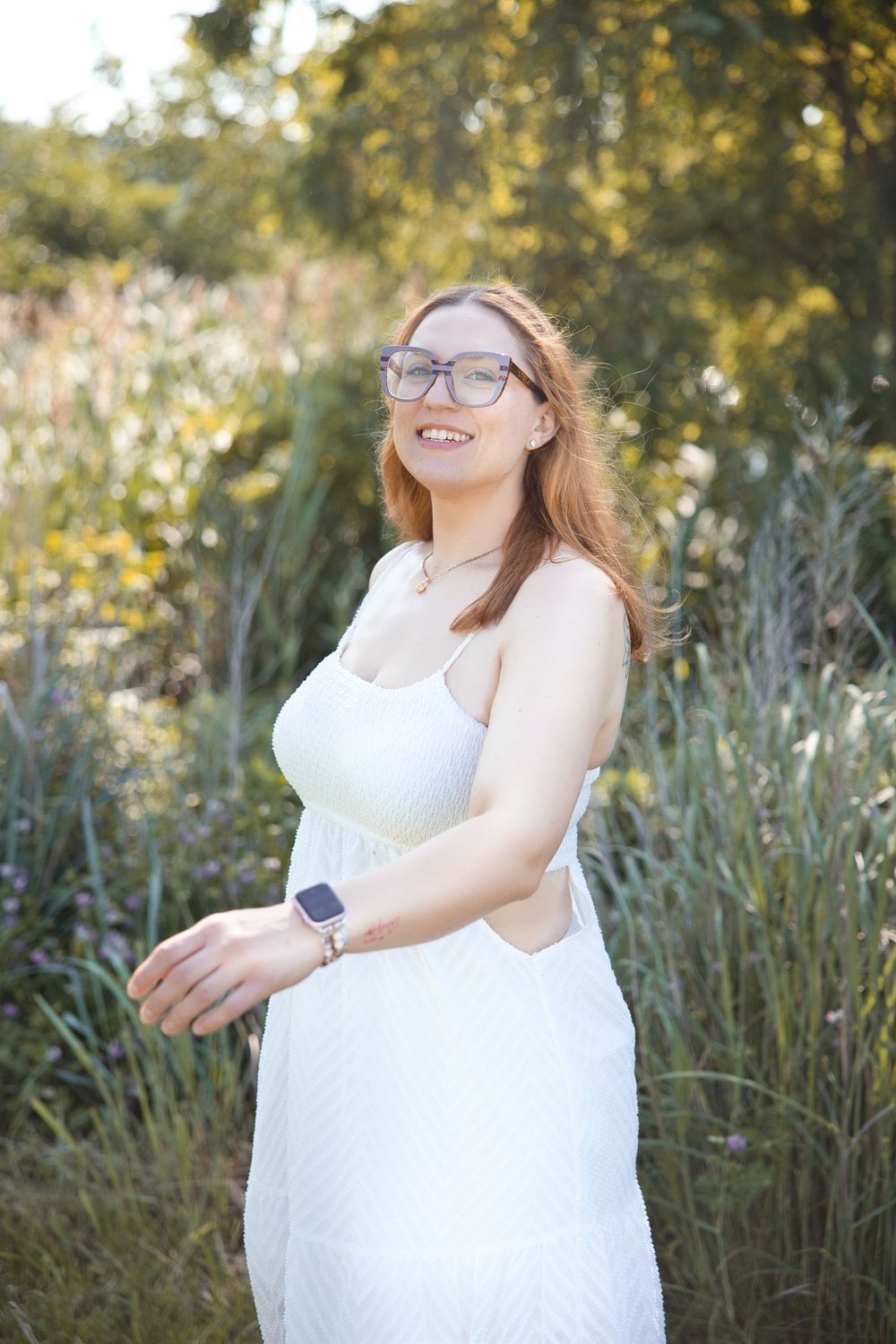Four connected photos of a person in a white lace dress posing gracefully in a natural outdoor setting with tall grass and trees.