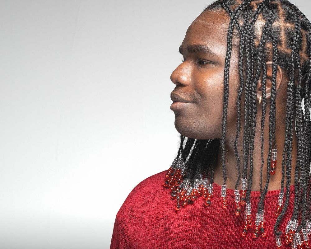 Profile view sequence showing someone with braided hair wearing a red sweater looking at different angles.