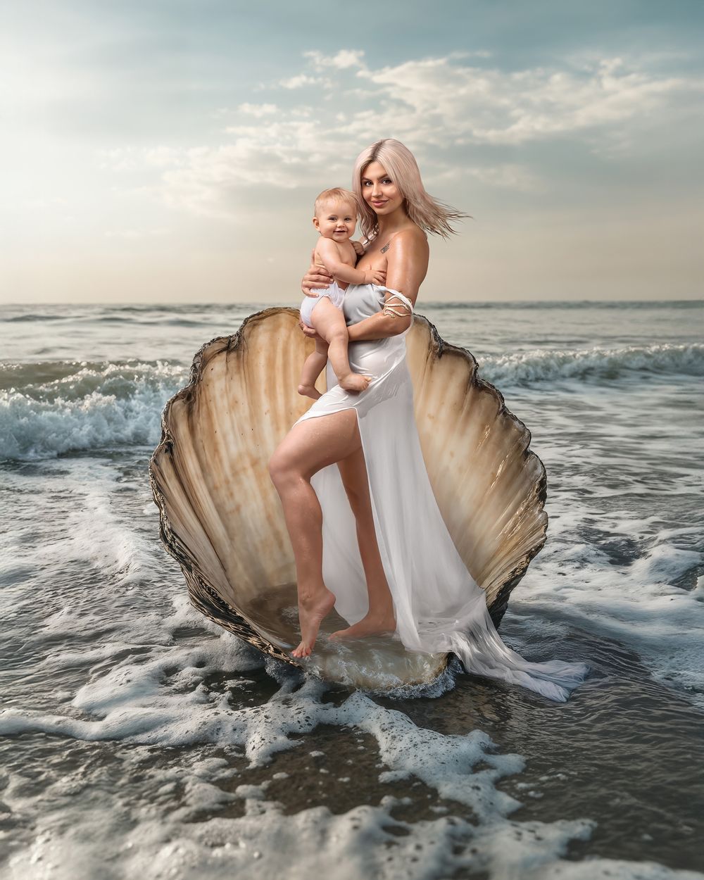 Sydney family photographer Caz Captures: motherhood portrait, mother holds daughter close their hair blows in the breeze, fine art studio.