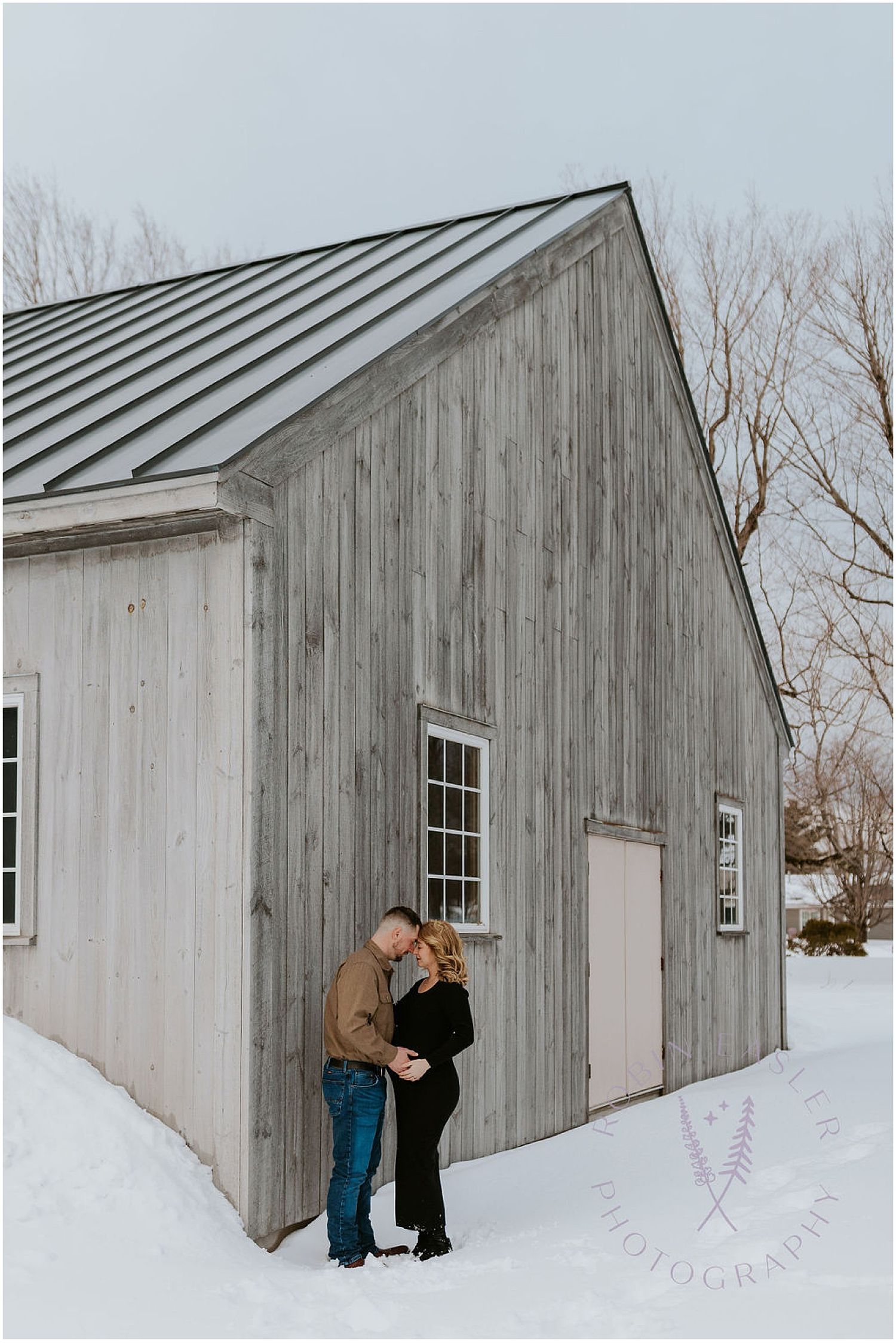NH couple taking maternity photos near a winter barn