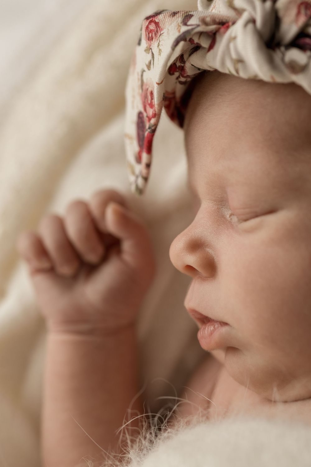 Close up of Newborn facial features for a newborn photoshoot. Floral newborn headband. Auckland newborn and family Photographer