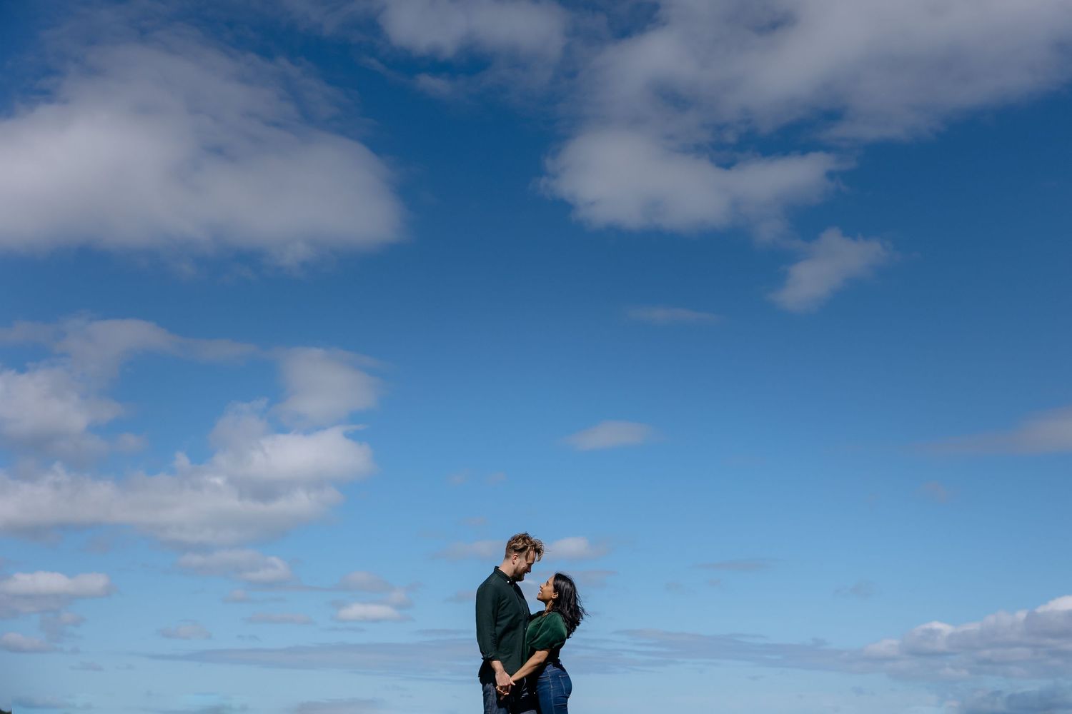 Couple holding each other and smiling at each other during a West Auckland engagement shoot