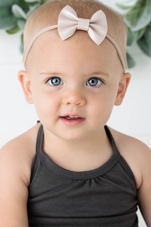 Southern California professional photographer's studio portrait of adorable baby girl with blue eyes.