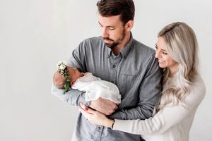 Wildomar baby photoshoot of happy parents holding their newborn baby.
