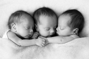 Professional newborn triplets photographer in Menifee California: Black and white photography of identical newborn triplets.