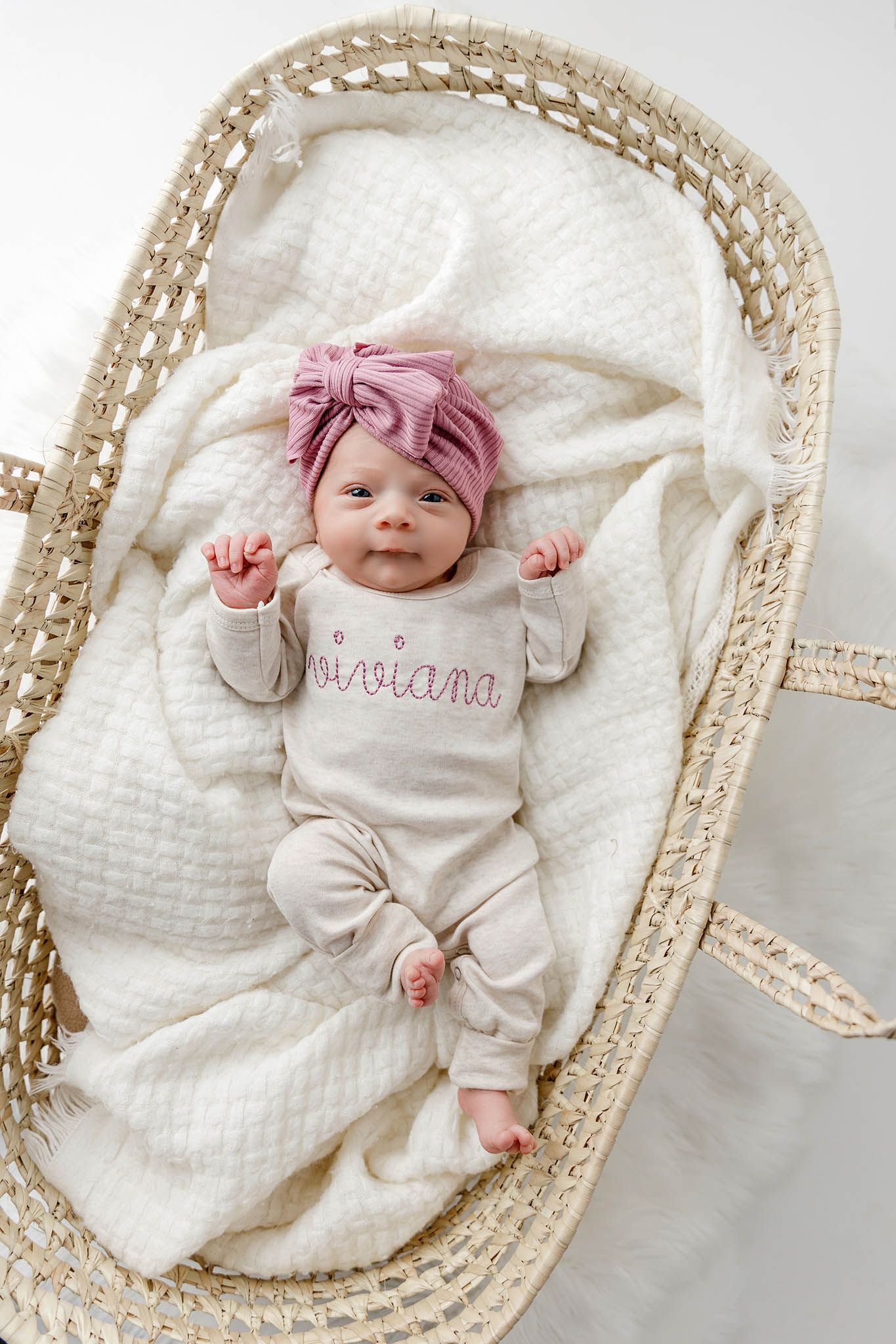 Lifestyle newborn photographer in Menifee photo of cute baby girl in Moses basket.