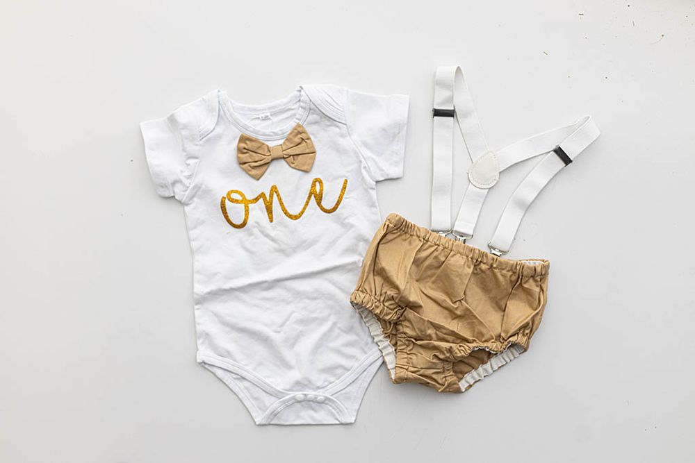 Baby boys first birthday outfit for cake smash photos in Inland Empire.