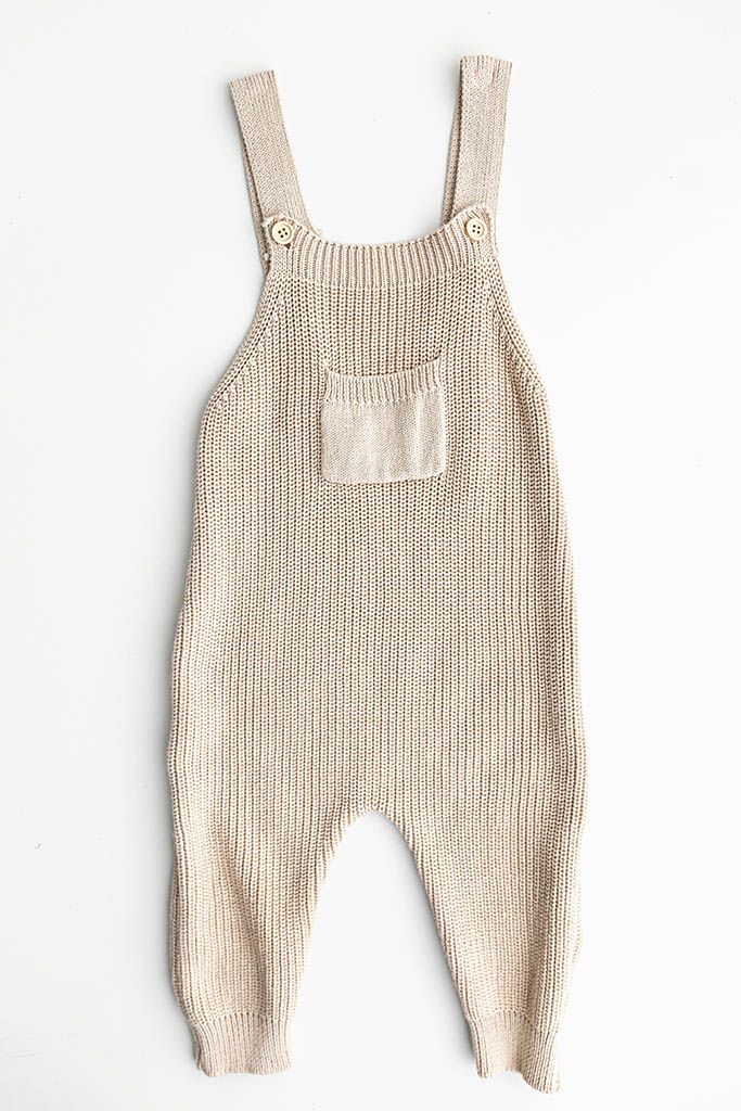 Beige chunky knit baby overalls with chest pocket and adjustable straps  for baby photography in Temecula CA.