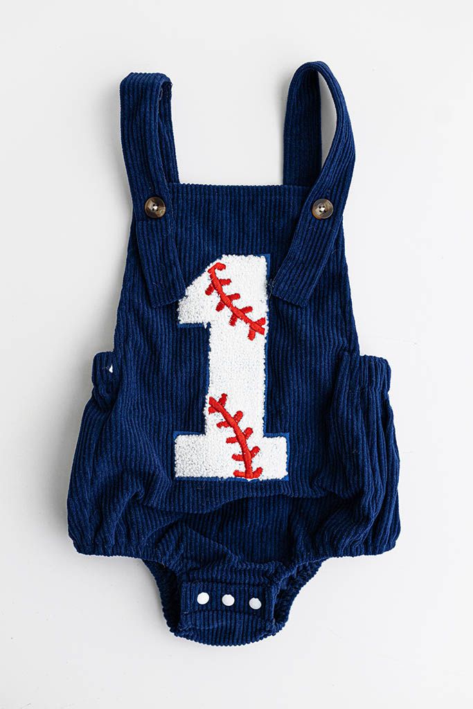 Navy blue corduroy baby romper with number one baseball patch for first birthday photos.