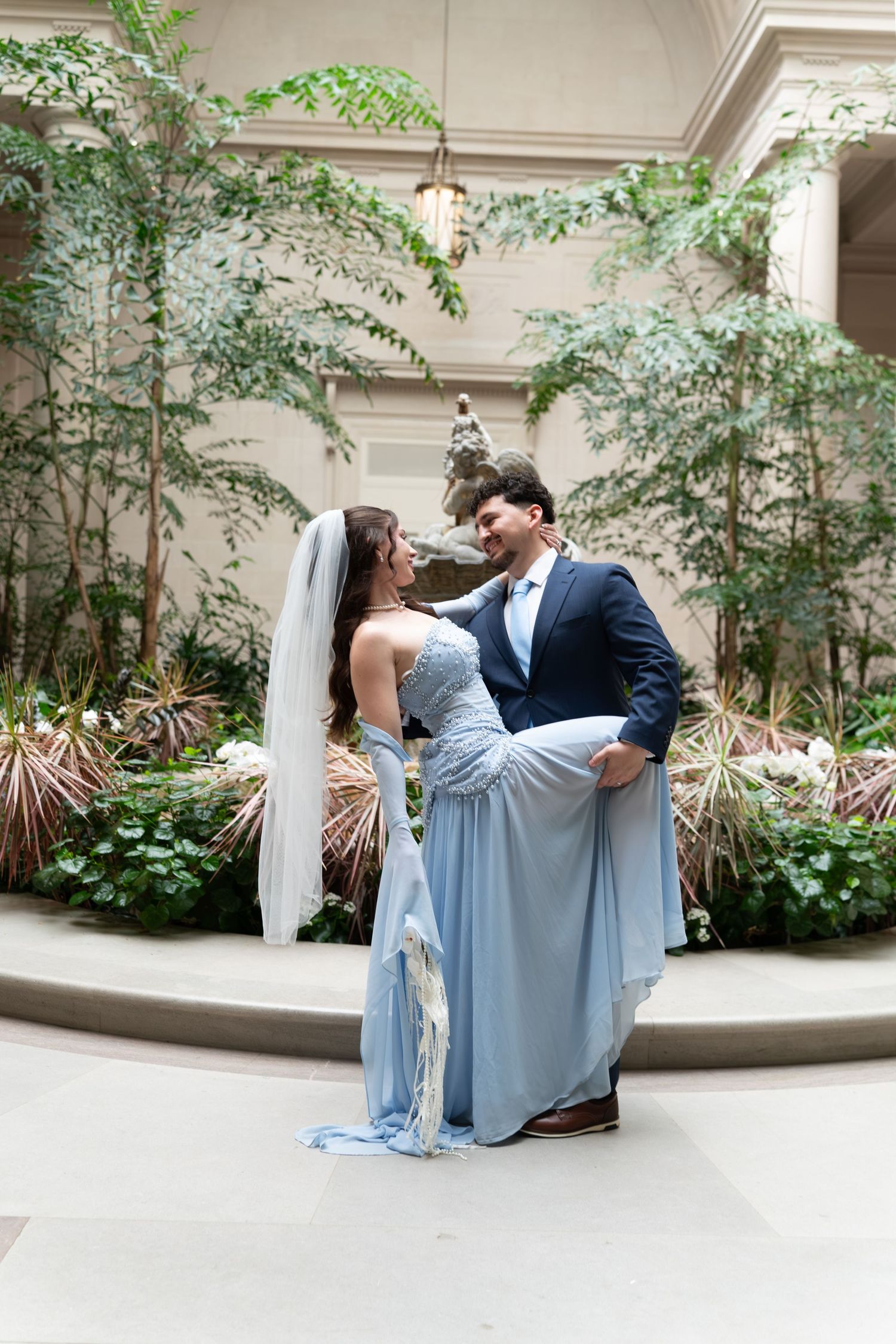 Wedding celebration featuring a stunning sparkly pink ballgown on a white dance floor with decorative elements.