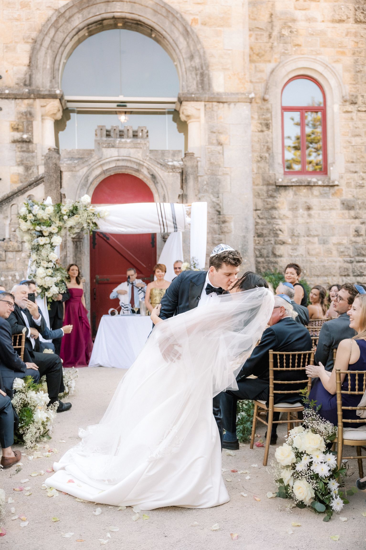 Emotional ceremony exit moment during Jewish wedding at Forte da Cruz