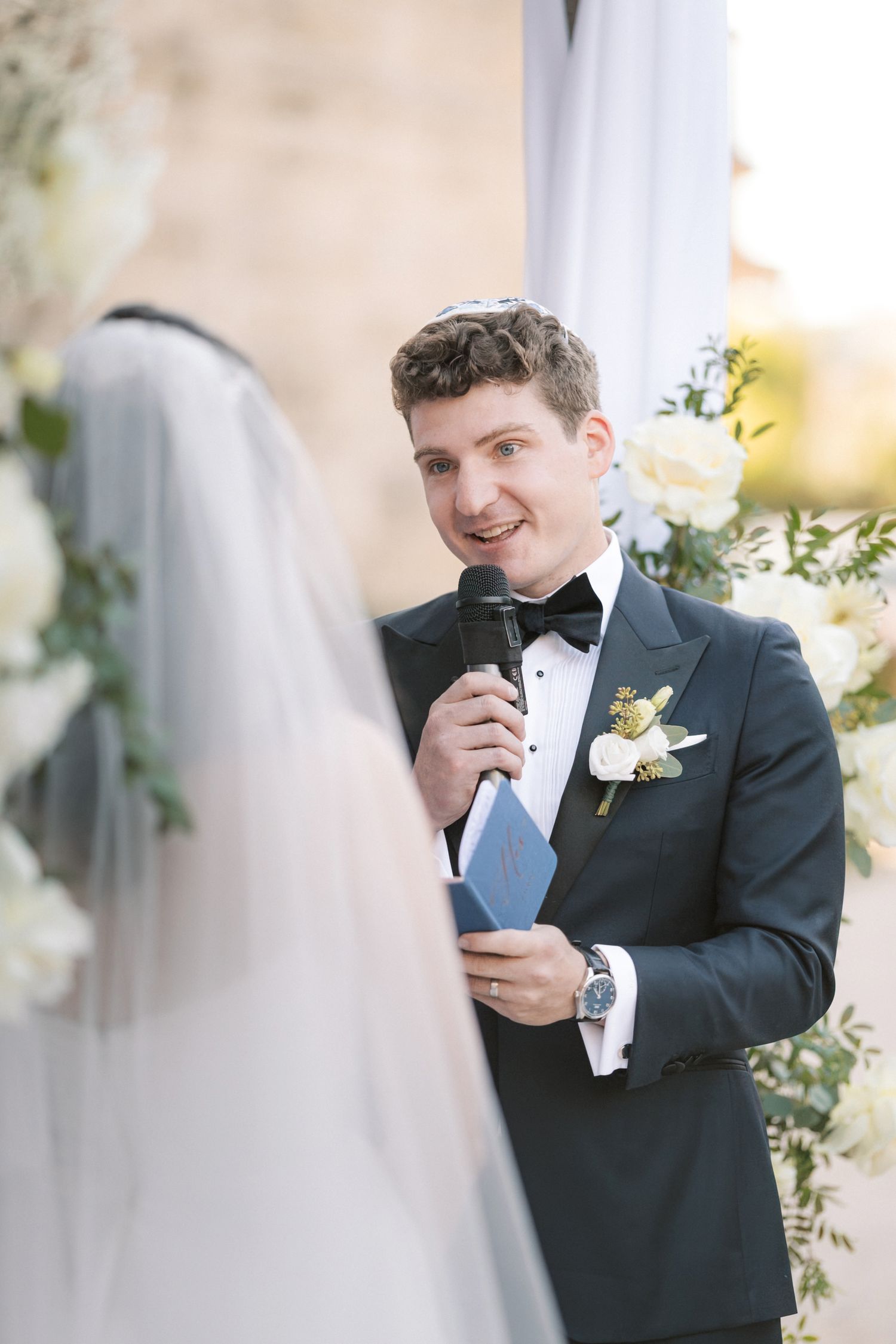 Bride and groom exchanging vows during Jewish wedding ceremony in Cascais Portugal