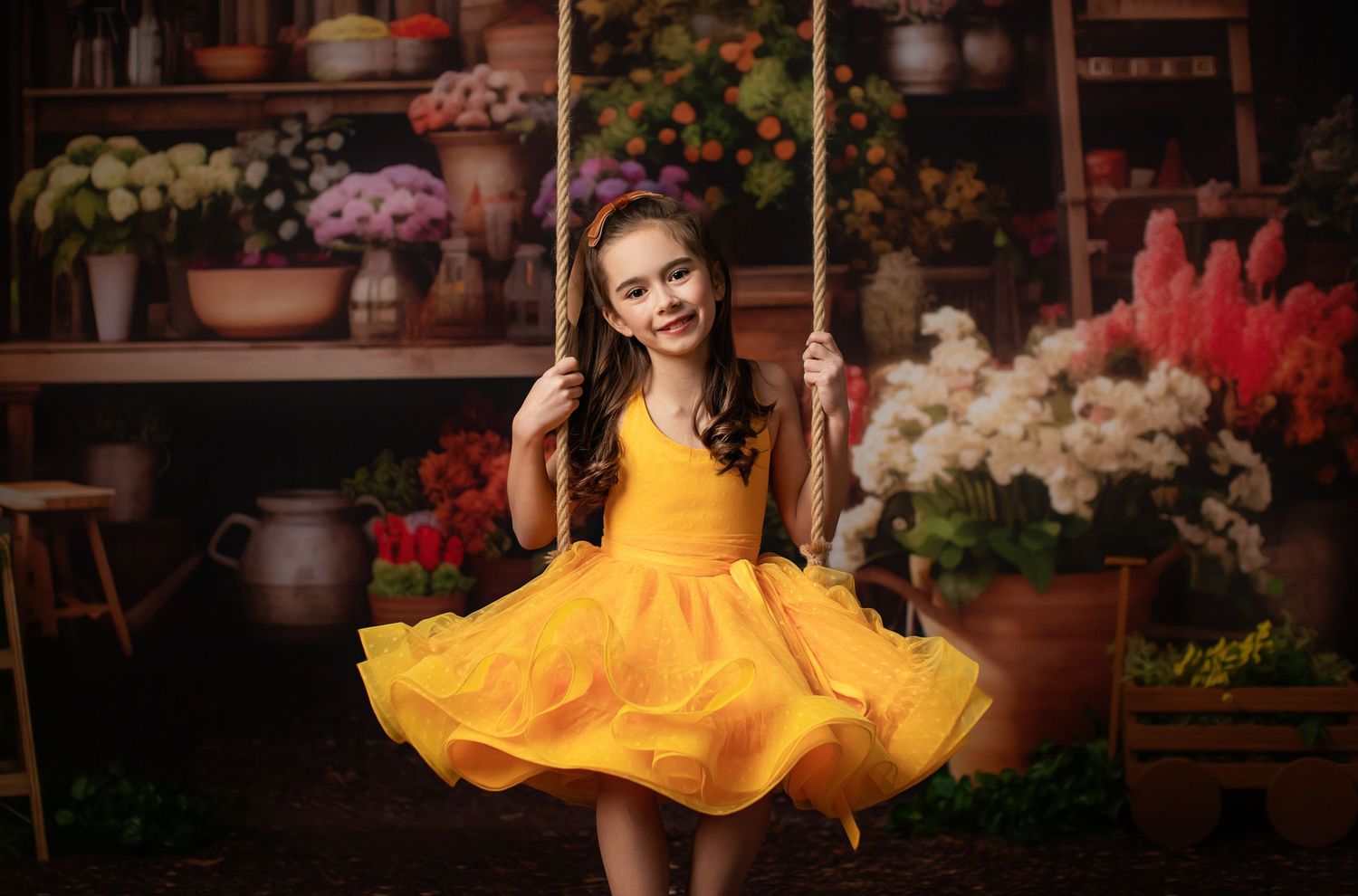 Yellow dress spins in charming garden shop setting surrounded by colorful flowers.