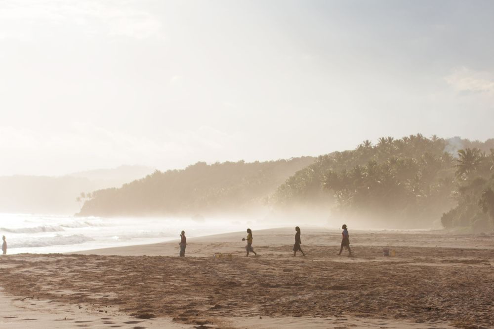 Local children on Nihiwatu Beach, at NIHI Sumba, Indonesia at sunset.