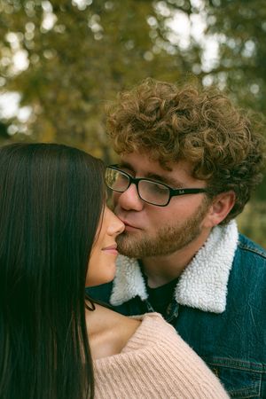 Romantic moment captured between couple during pregnancy announcement photoshoot.