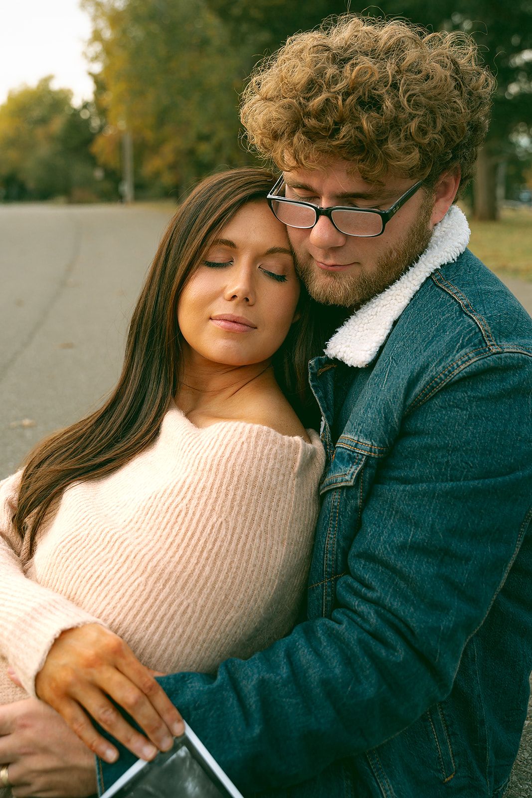 Intimate moment captured between two people in casual wear on autumn day.