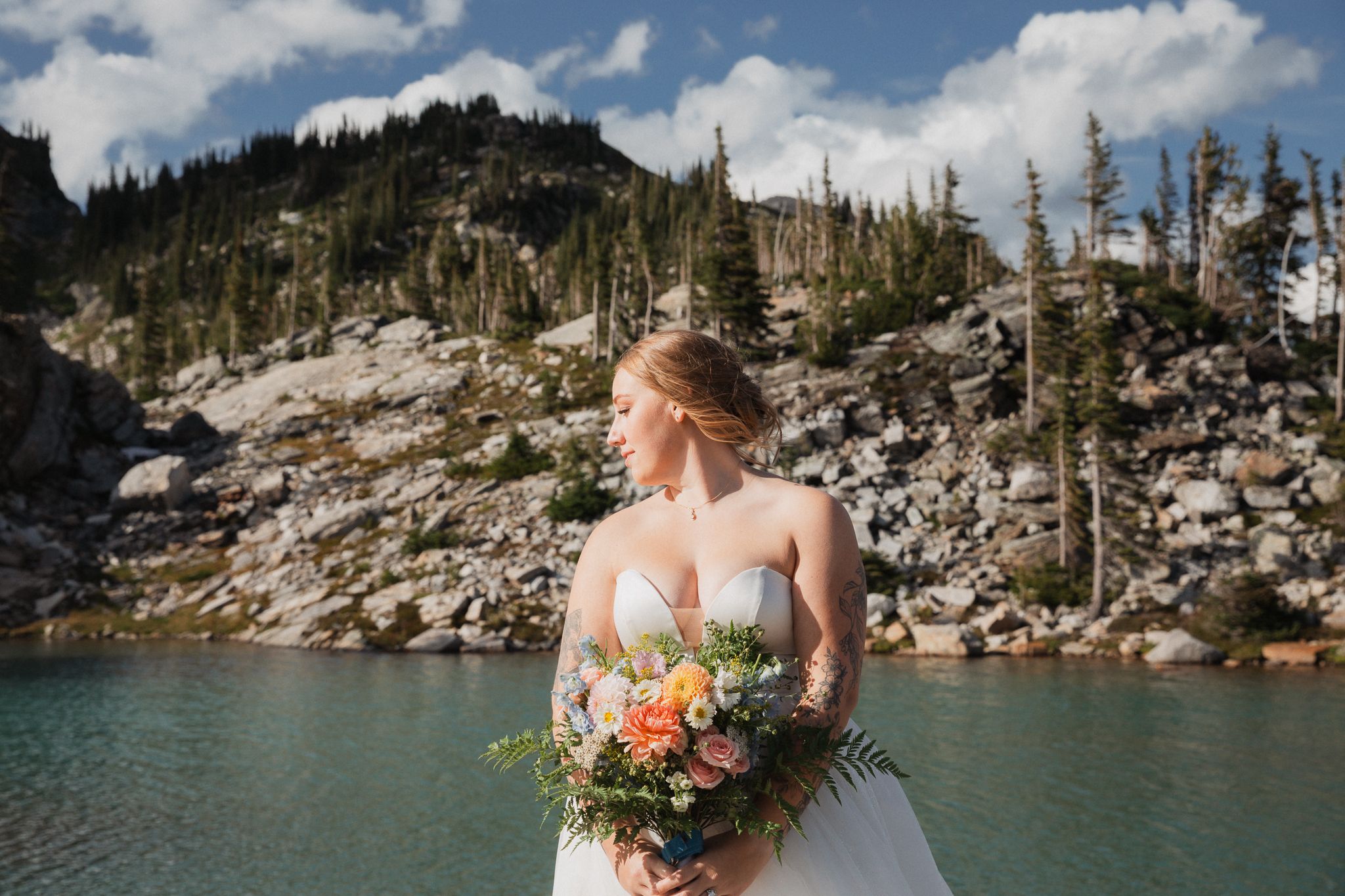 This was a fairytale elopement in Revelstoke, BC with Glacier Helicopters. The mountain top, skyline, and pastel wildflowers were a dream!