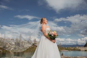 This was a fairytale elopement in Revelstoke, BC with Glacier Helicopters. The mountain top, skyline, and pastel wildflowers were a dream!