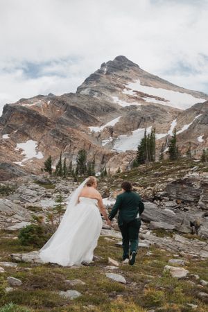 This was a fairytale elopement in Revelstoke, BC with Glacier Helicopters. The mountain top, skyline, and pastel wildflowers were a dream!