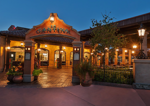Exterior of Mexican cantina restaurant lit up at night with warm lighting.