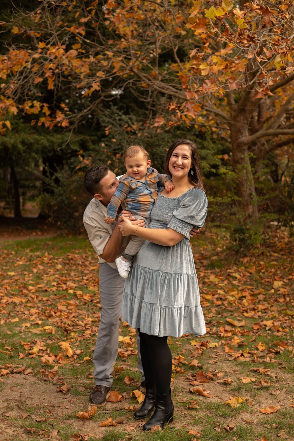 Candid family interactions captured during an autumn outdoor photo session.