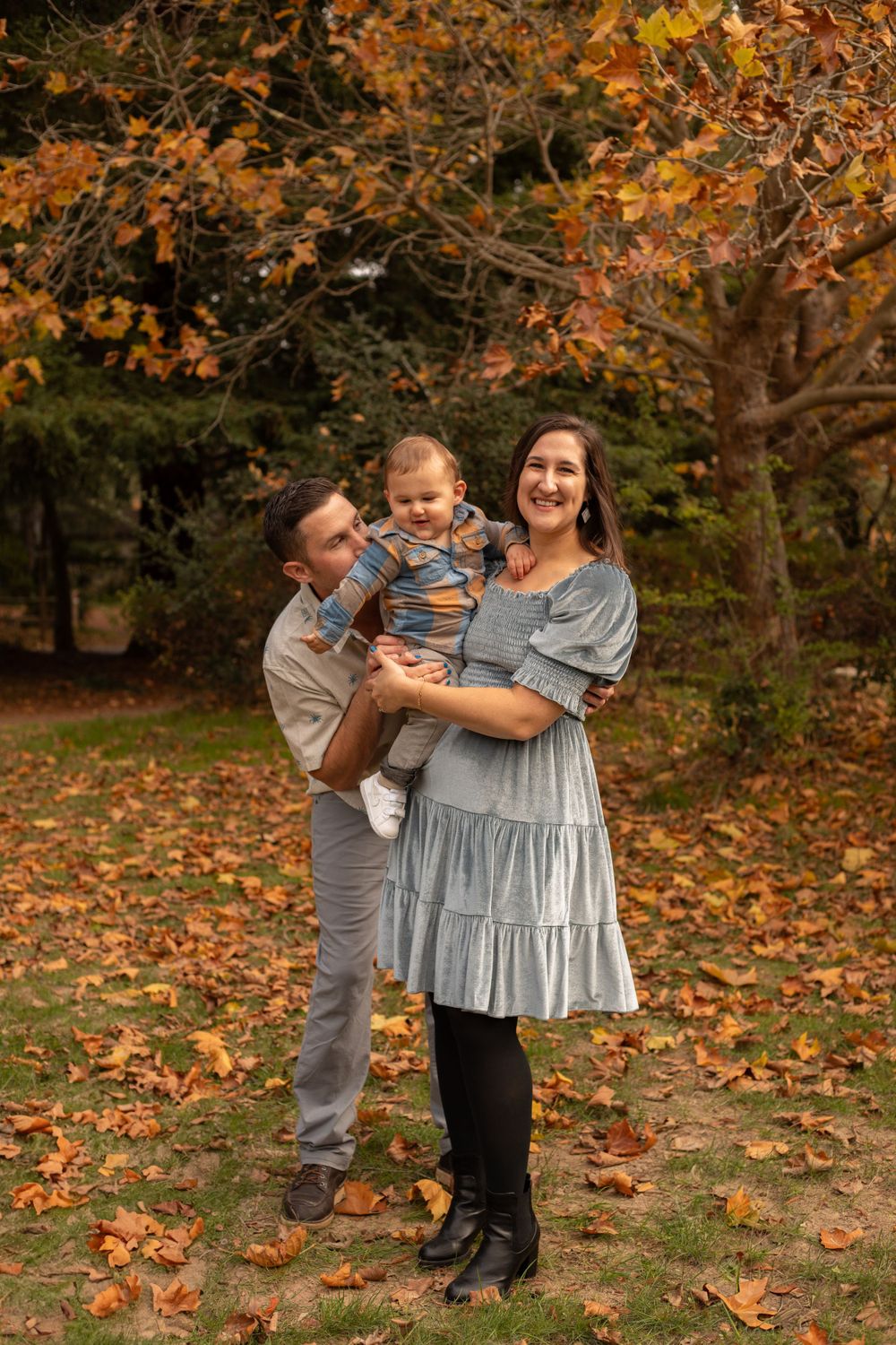 Joyful family moments photographed against a backdrop of colorful fall trees.