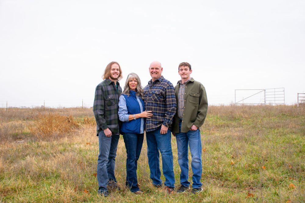 Family photographed outdoors by Roam Media