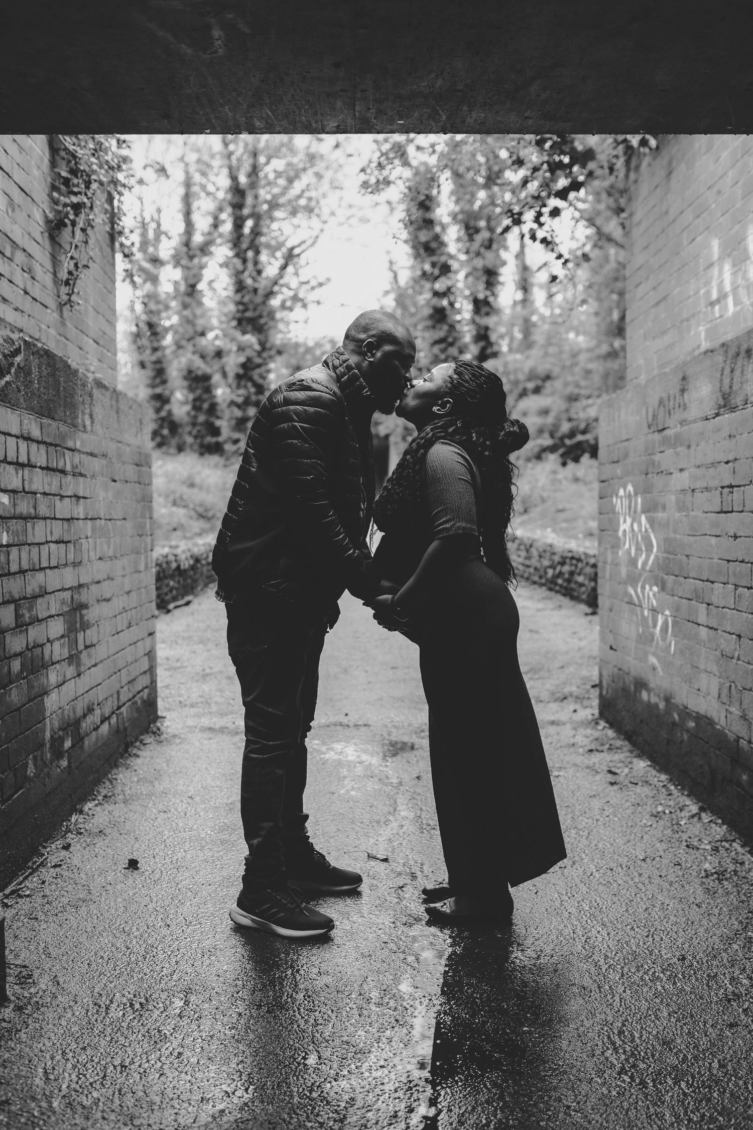 Black and white photo of couple walking together down brick-lined path. Photographer. Hull. East Yorkshire. Photography
