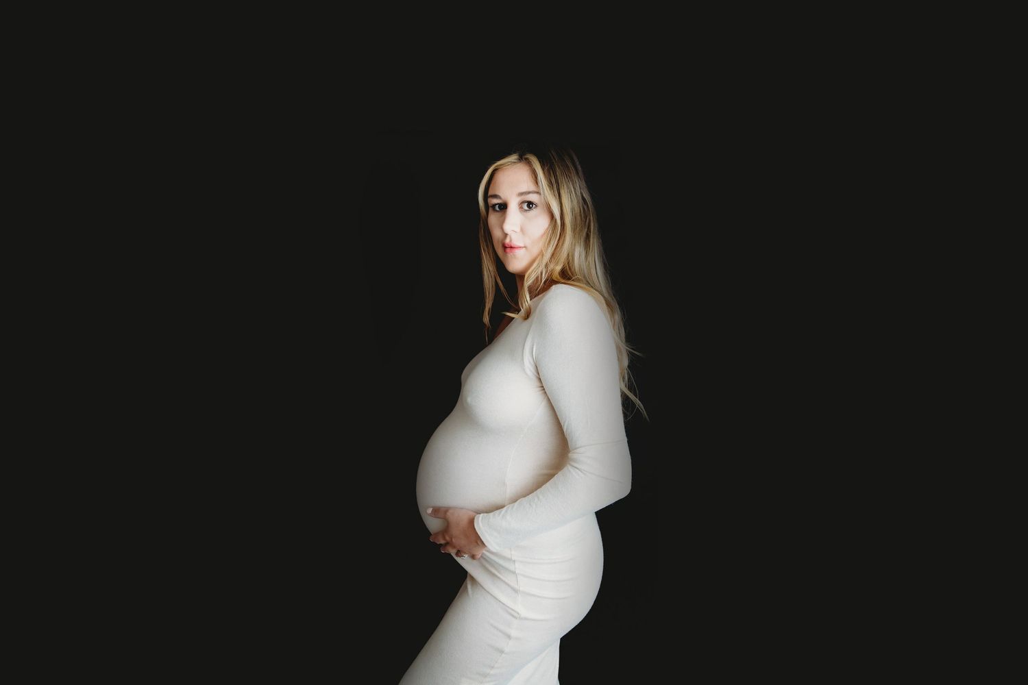Dramatic maternity portraits on black background showing silhouette. Photographer. Hull. East Yorkshire. Photography