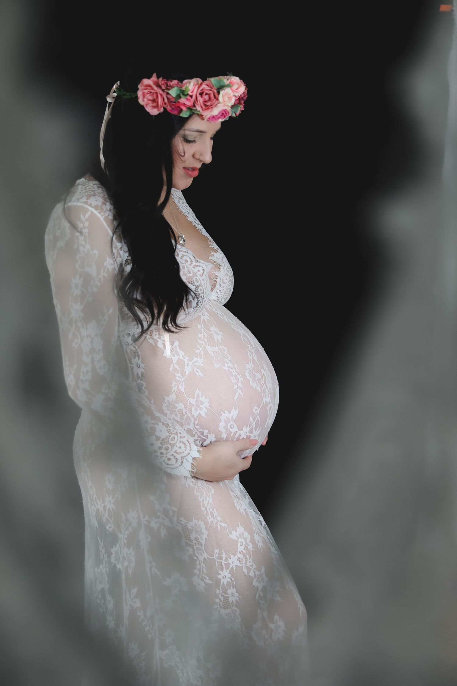 Ethereal maternity portrait in white lace dress with floral crown against dark background. Photographer. Hull. East Yorkshire. Photography