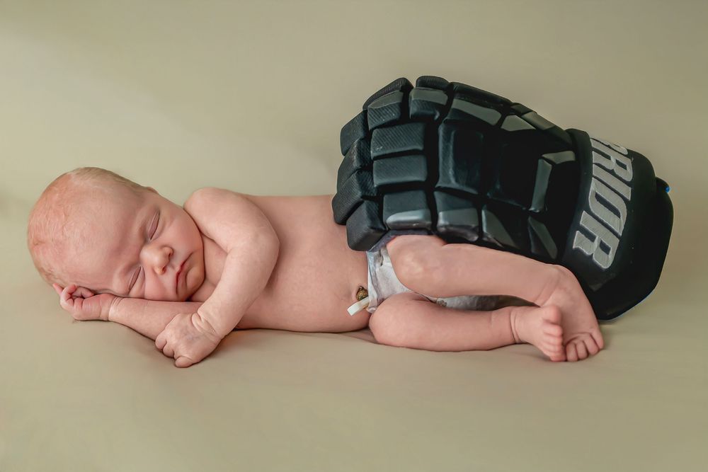 Series of close-up shots showing a sleeping newborn baby in different poses against a neutral backdrop.