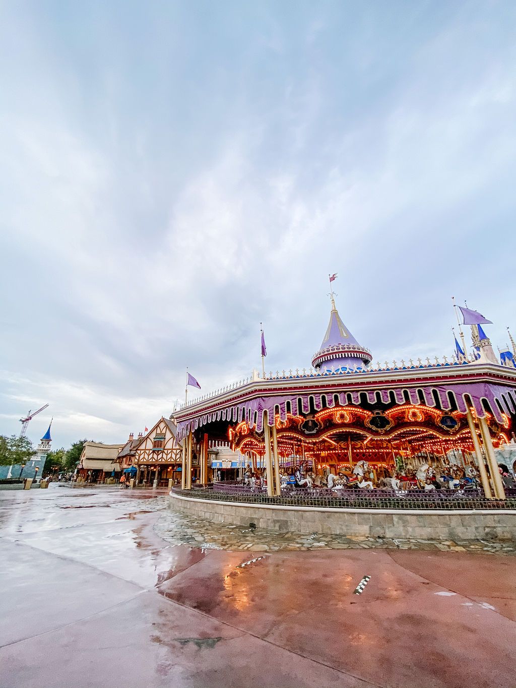 Prince Charming Regal Carousel in Magic Kingdom features ornate details under cloudy skies at Walt Disney World.