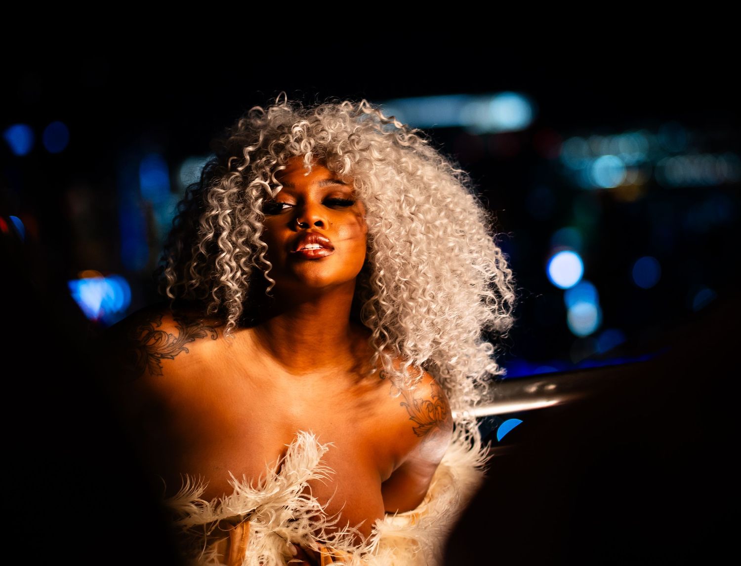 Artistic boudoir photography with warm lighting and dramatic shadows creating an intimate mood.