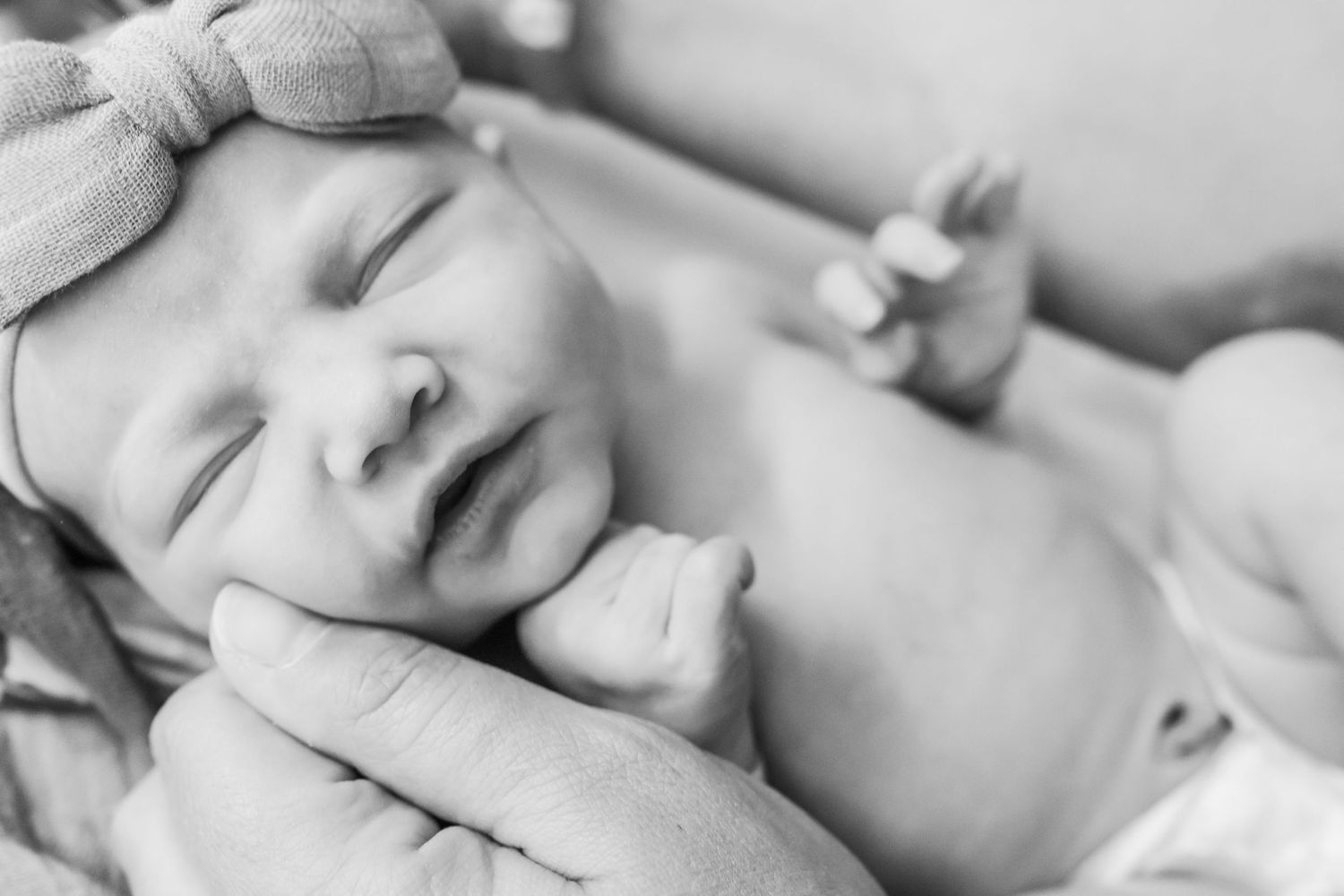 Series of black and white close-up shots of sleeping newborn.